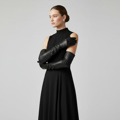 Above the elbow long black leather gloves worn by a young woman