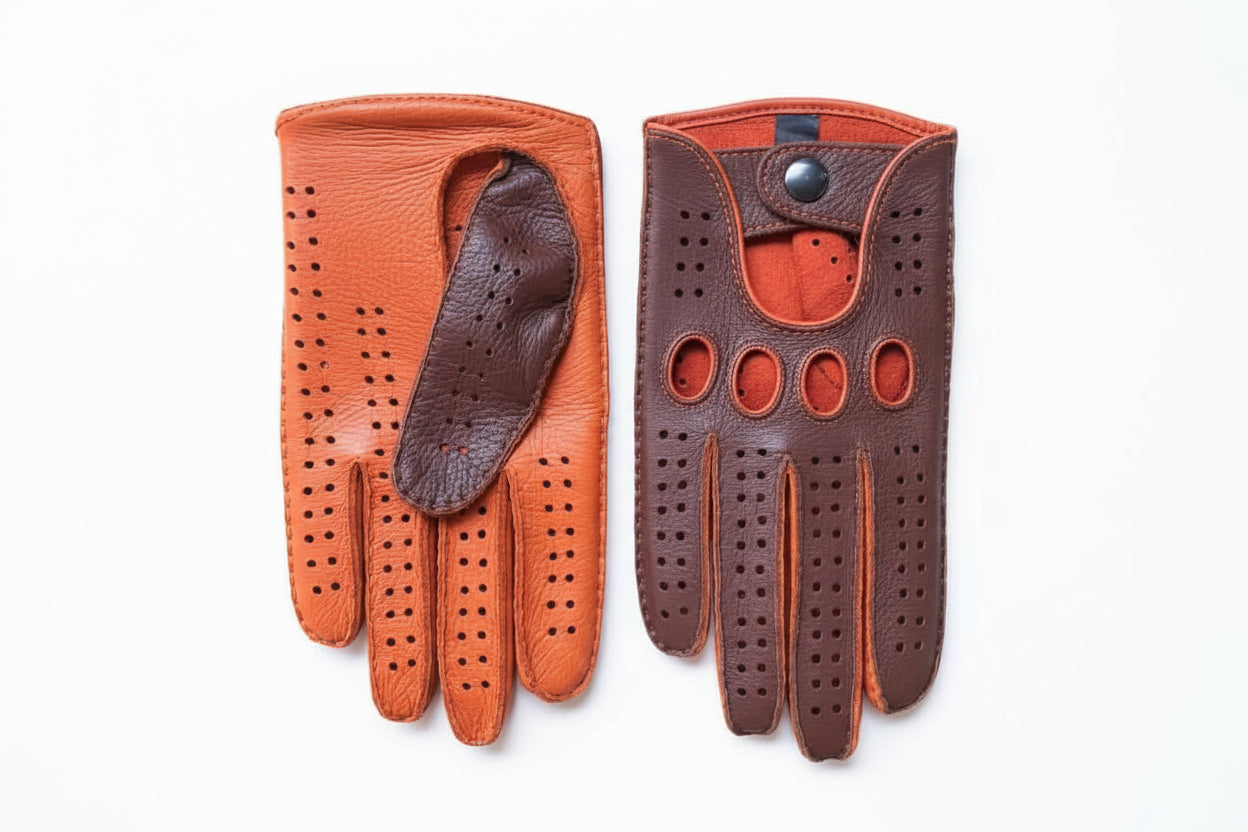 Pair of brown leather driving gloves on a textured surface